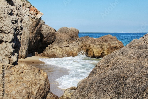 Crystalline waters and rock textures of Galapinhos Beach photo