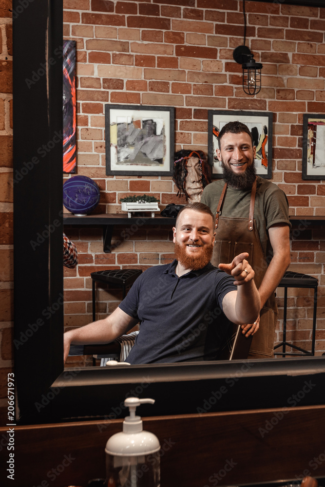 Barber and bearded man in barber shop