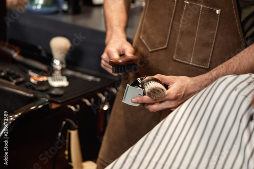 Barber and bearded man in barber shop