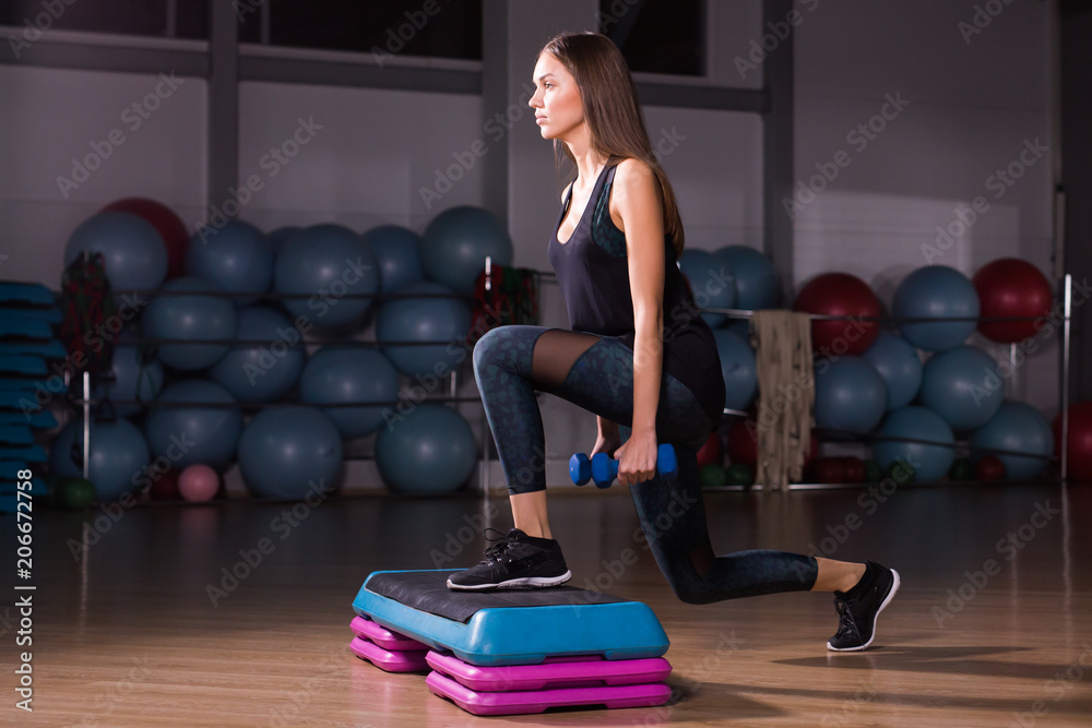 Sporty woman practice on step platform in gym Sporty woman practice on step platform in gym