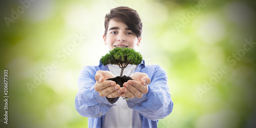 young tree in hands, conservation and nature