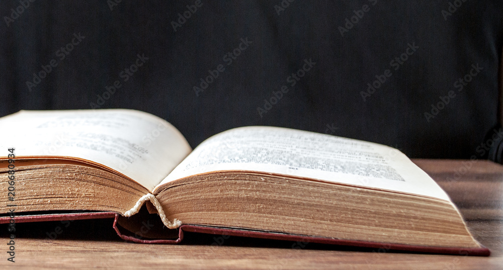 unfolded book on a black background unfolded book on a black background