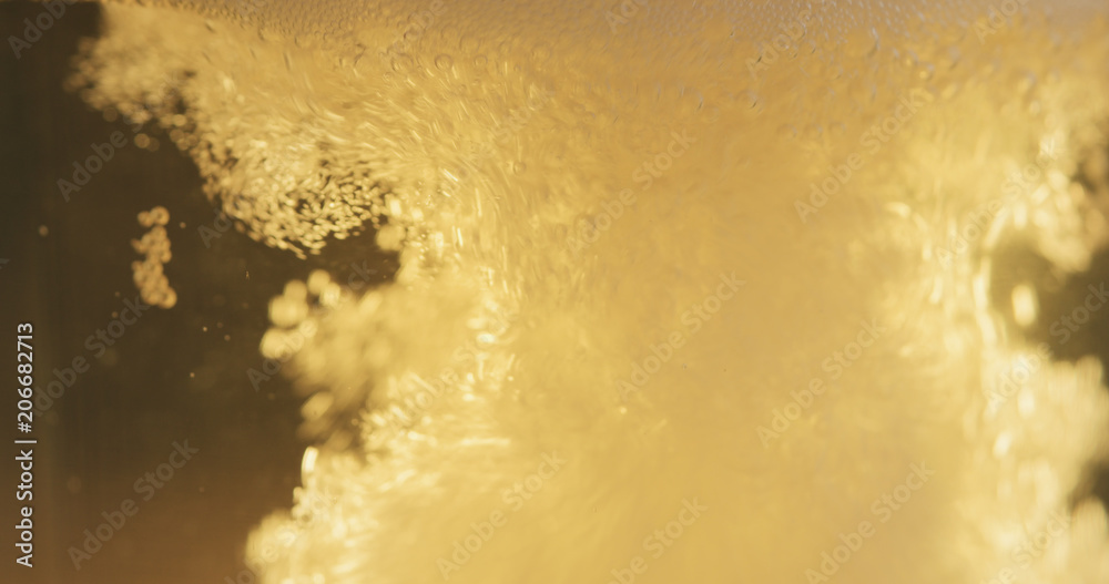 Obraz premium closeup of lager beer pouring in a glass