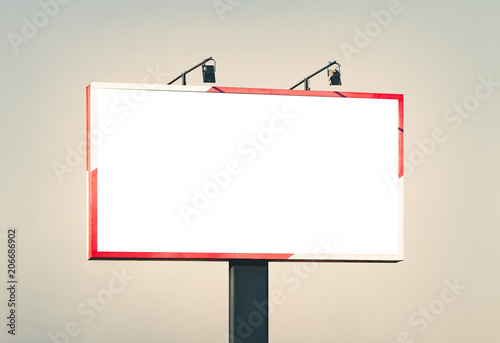 Blank horizontal billboard against a blue sky. photo