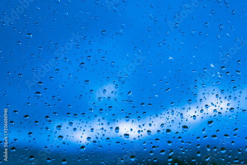 Drops of rain on blue glass background