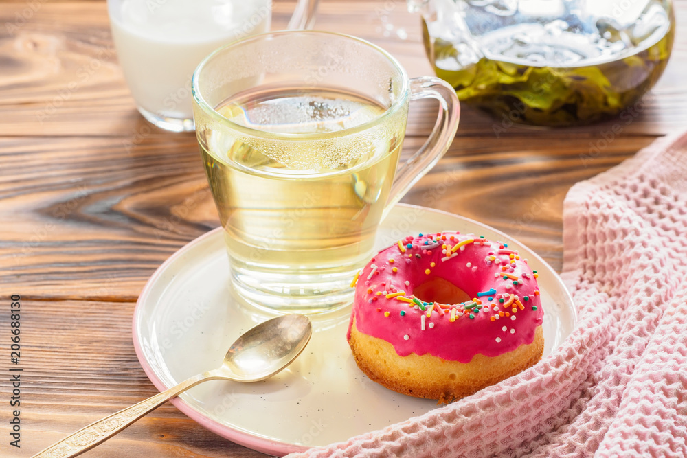 Cup of hot green tea beverages with donut glazed Cup of hot green tea beverages with donut glazed