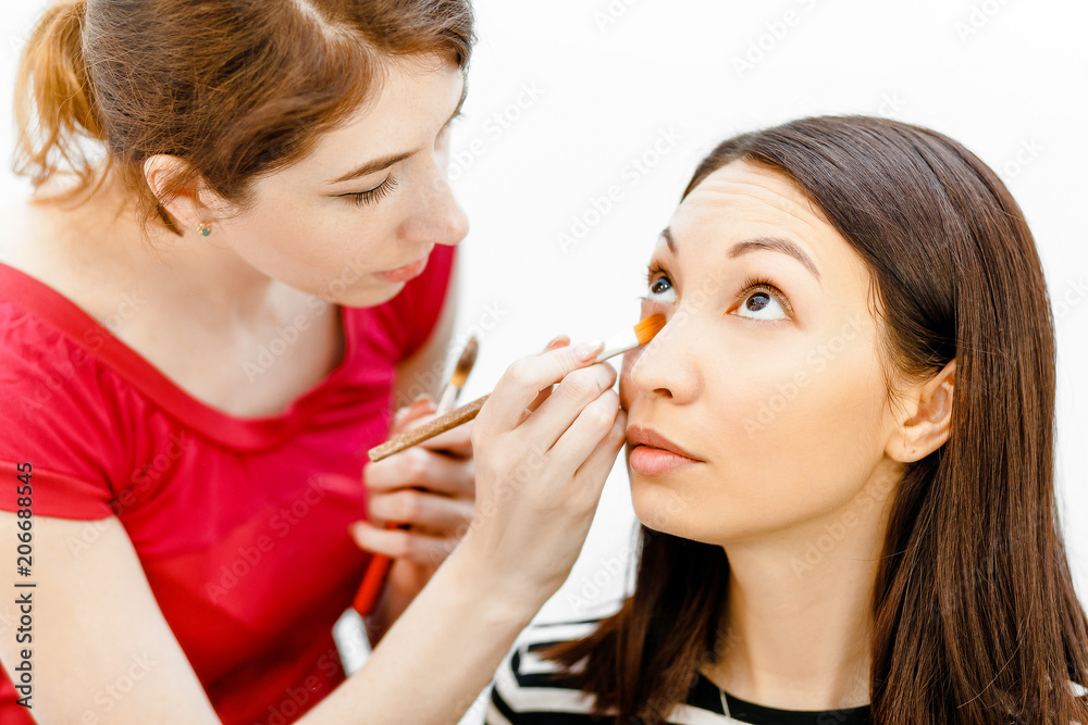 make-up artist doing professional visage to her friend in beauty salon make-up artist doing professional visage to her friend in beauty salon
