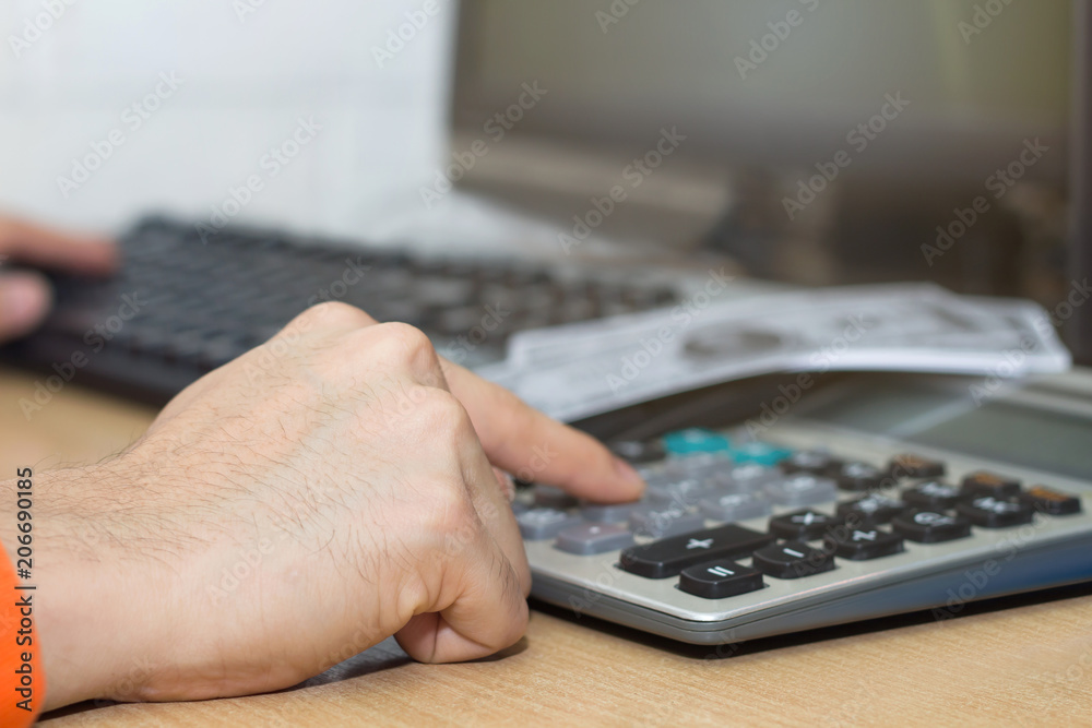 A businessman calculate money by calculator with banknotes on work A businessman calculate money by calculator with banknotes on work