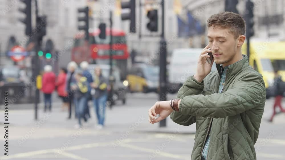 Attractive mixed race man using his phone outdoors in the city Attractive mixed race man using his phone outdoors in the city
