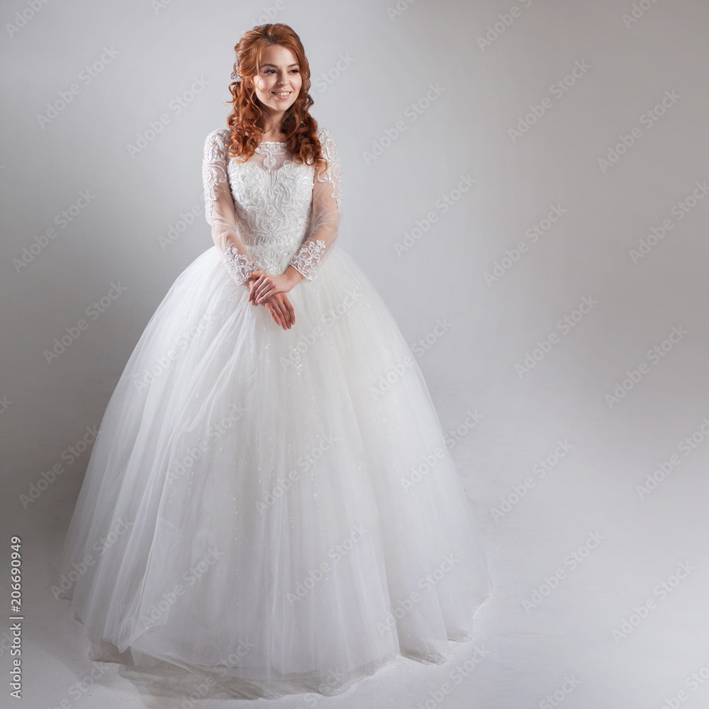 Magnificent wedding dress with a crinoline, classic style. Woman bride in lavish wedding dress. Light background. Magnificent wedding dress with a crinoline, classic style. Woman bride in lavish wedding dress. Light background.