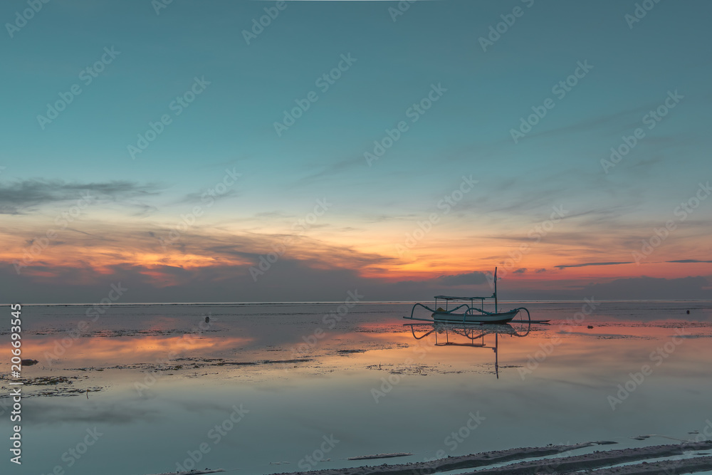 An old traditional indonesian fishing boat at sunrise