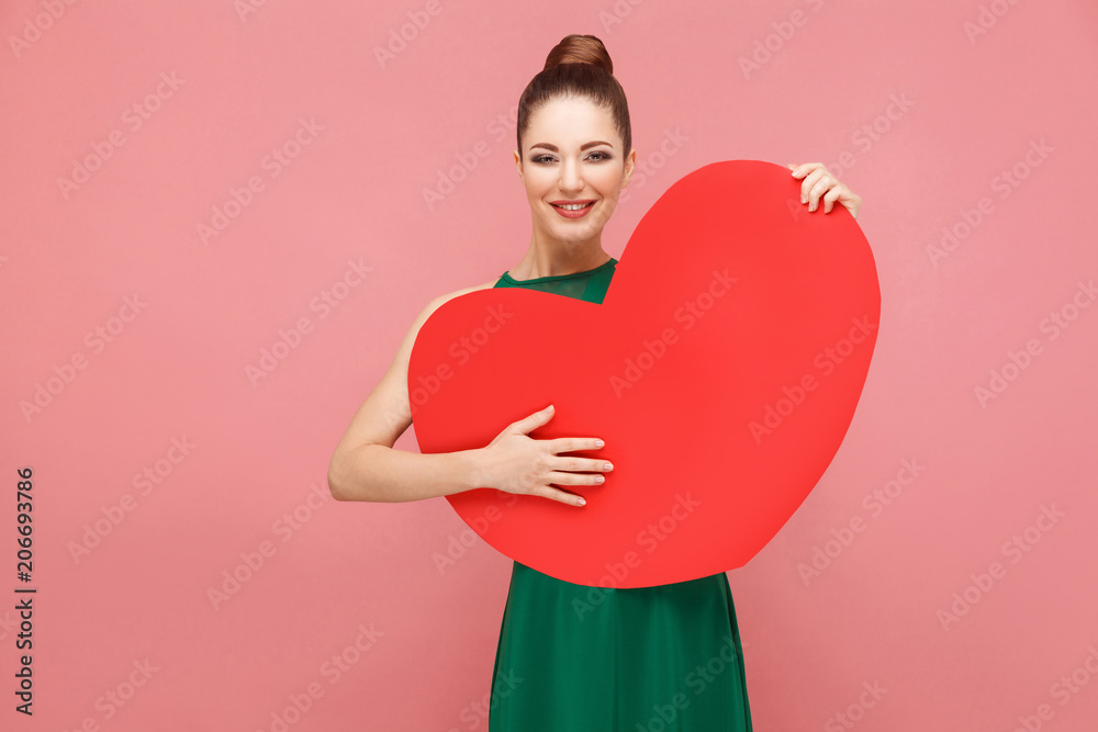 Happiness woman embrace big red heart, toothy smiling Happiness woman embrace big red heart, toothy smiling