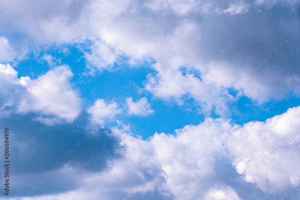 Background of transparent white clouds in a light blue sky illuminated by the sun. Background of transparent white clouds in a light blue sky illuminated by the sun.