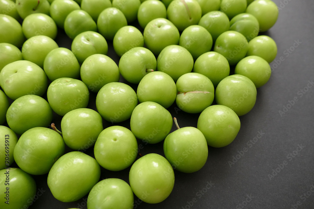 green sour plums,wonderful fresh green plums on black ground
green sour plums,wonderful fresh green plums on black ground