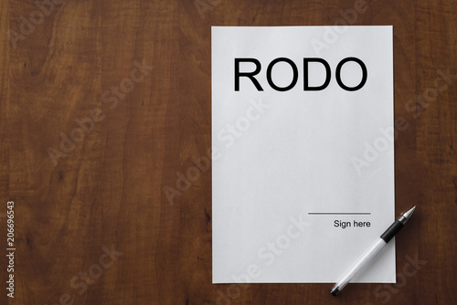 RODO - Rozporzadzenie Ogolne o Ochronie Danych Osobowych is European Union safety regulations. White sheet of paper on the wooden desk with pen. Blank space on the paper and copy space. GDPR photo