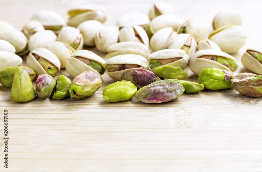 Pistachios on the wooden table. Pistachios on the wooden table.