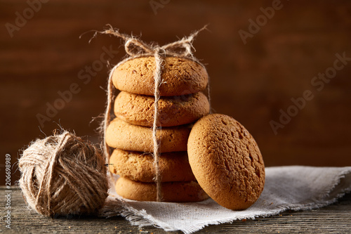 Pile of oat cookies on wooden table, close-up, selective focus. photo
