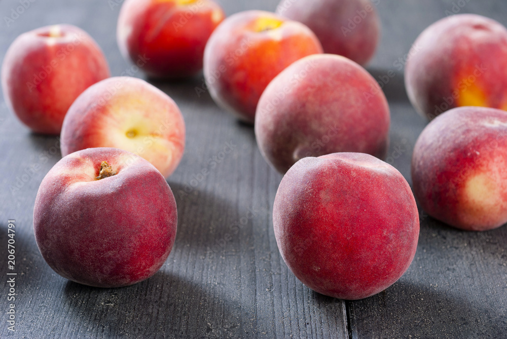 ripe homegrown peaches on black wooden table ripe homegrown peaches on black wooden table