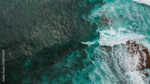 Aerial view from a surf spot with waves and a two surfers in Ericeira, Portugal