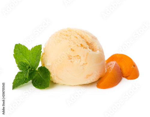 Ball apricot ice cream with pieces of fresh apricot and mint leaves isolated on white