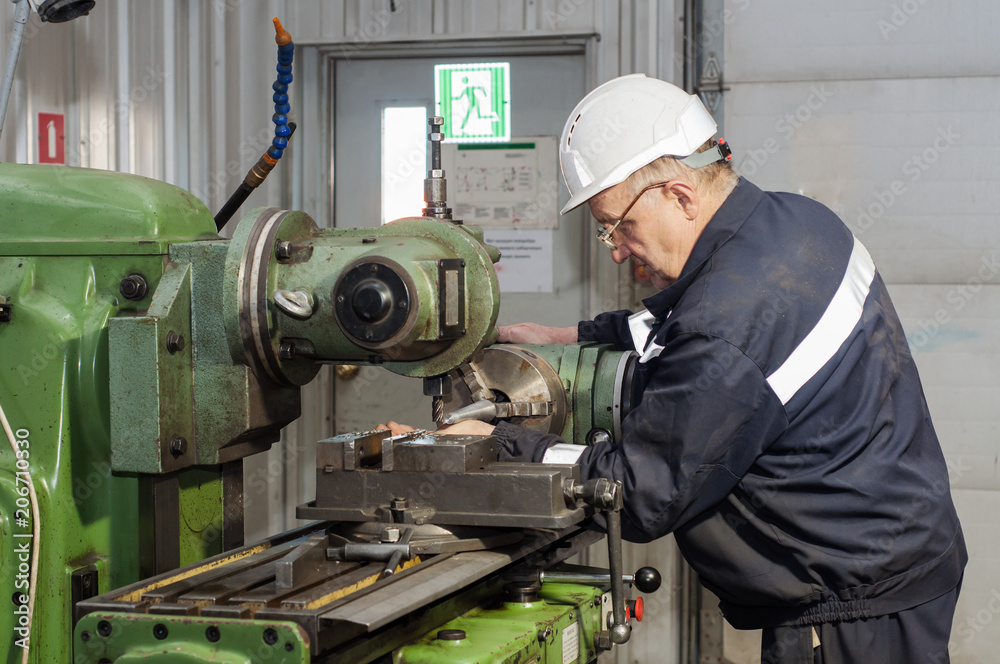 mechanic using industrial lathe machine mechanic using industrial lathe machine