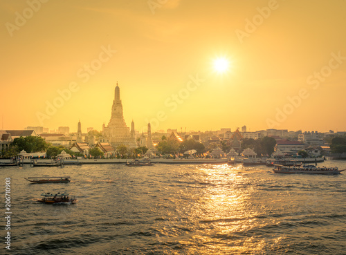 Wat Arun at sunset time ,Bangkok, Thailand. The Temple of Dawn,The boat was sailing in Chao Phraya River Bangkok ,The Chao Phraya is the major river in Thailand