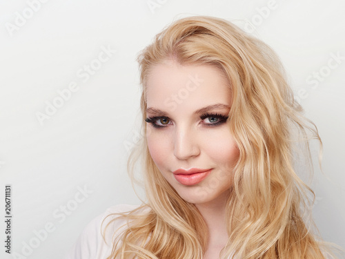 Beauty portrait of model with trendy natural make-up. Fashion shiny highlighter on skin, sexy gloss lips make-up.