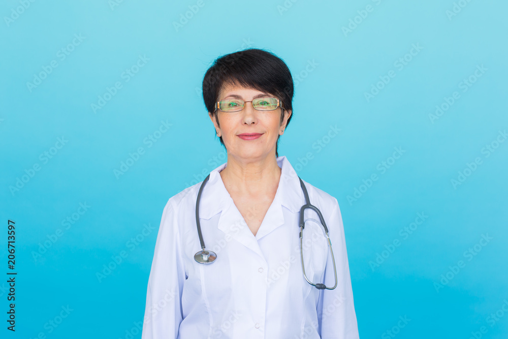 Smiling medical doctor woman with stethoscope. Over blue background with copy space Smiling medical doctor woman with stethoscope. Over blue background with copy space