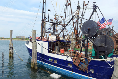 Tablou pe pânză Commercial fishing boat near dock before sailing into the ocean