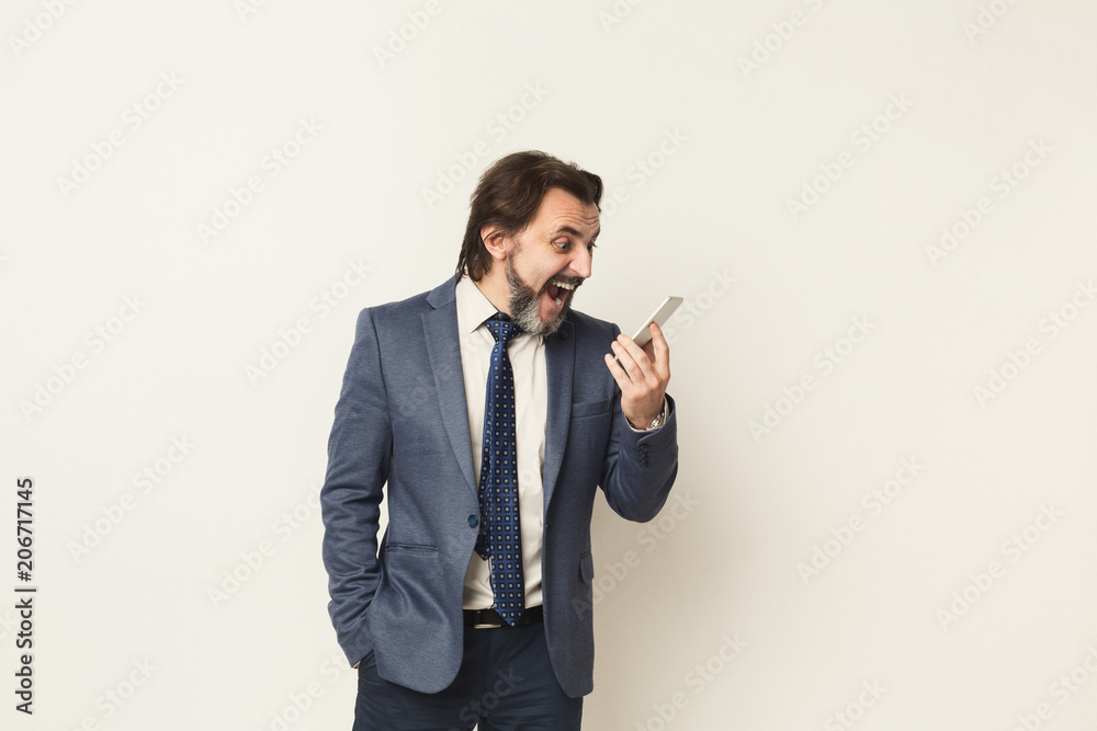 Angry businessman crying on phone at white background Angry businessman crying on phone at white background