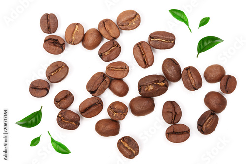Coffee beans decorated with green leaves isolated on white background. Top view