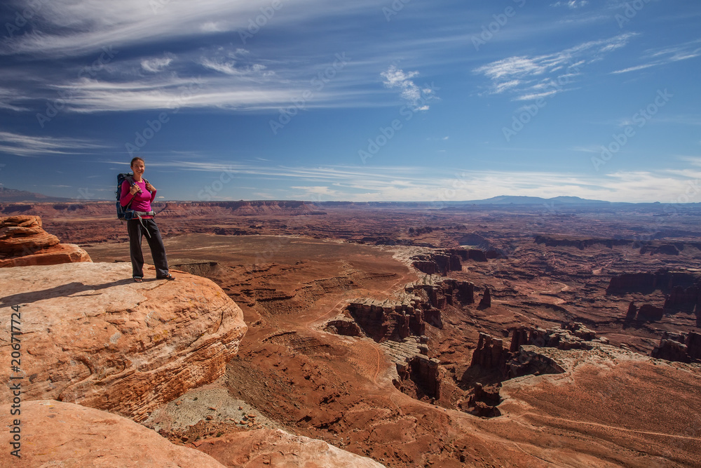 Fototapeta premium Hiker rests in Canyonlands National park in Utah, USA