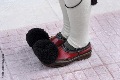 Greece, Athens: Detail close up of traditonal boots of the Presidential Guard soldiers (Evzones or Evzonoi) in the city center of the Greek capital - concept history tradition ceremony elite military photo