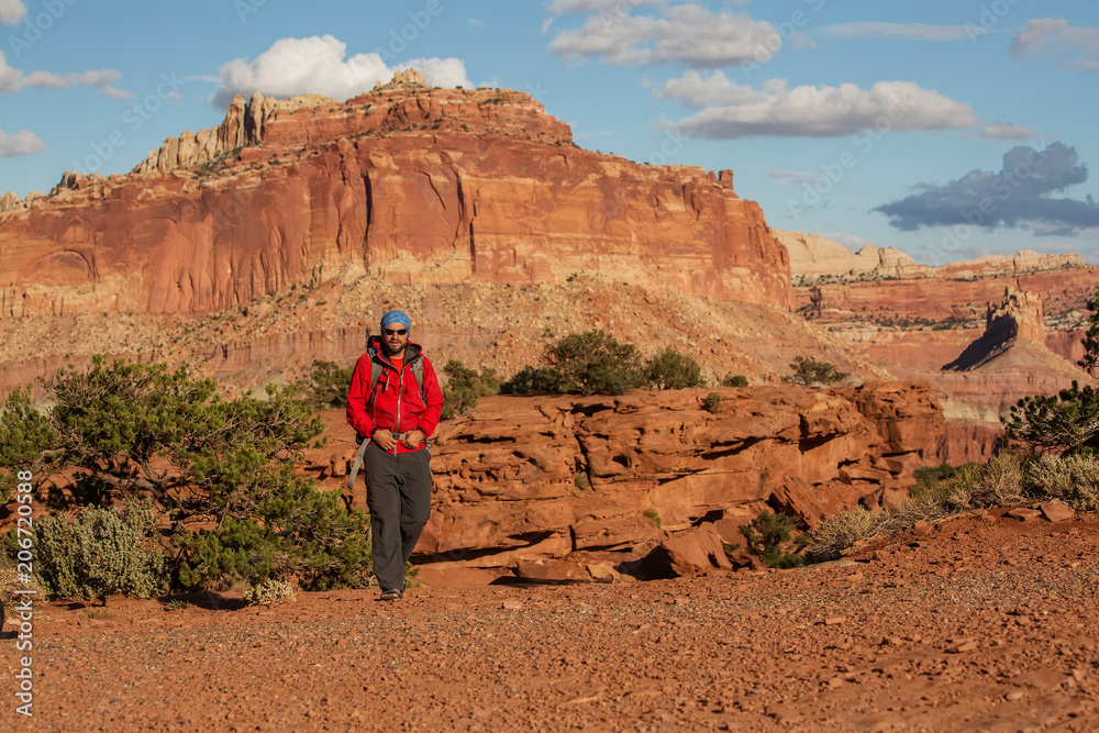 Hiker in Capitol reef National park in Utah, USA Hiker in Capitol reef National park in Utah, USA