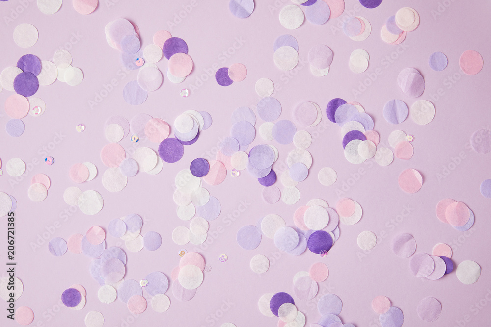 top view of scattered violet confetti pieces on surface
