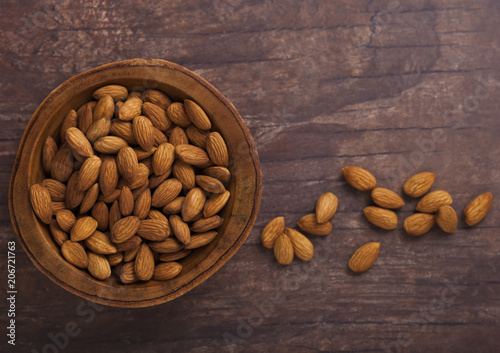 Wooden bowl with fresh raw almond nuts