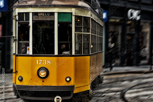 Old vintage Milan yellow tram , streetcar and public transport photo