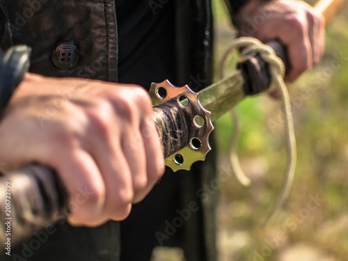 Samurai sword katana in hand. Katana sword holding in Samurai hand prepare to flighting. photo