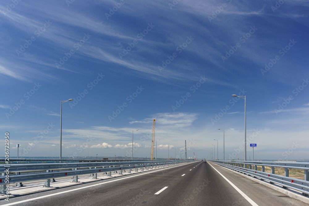 Fototapeta premium Cars driving on the Tuzla spit on the Taman Peninsula on a Sunny day