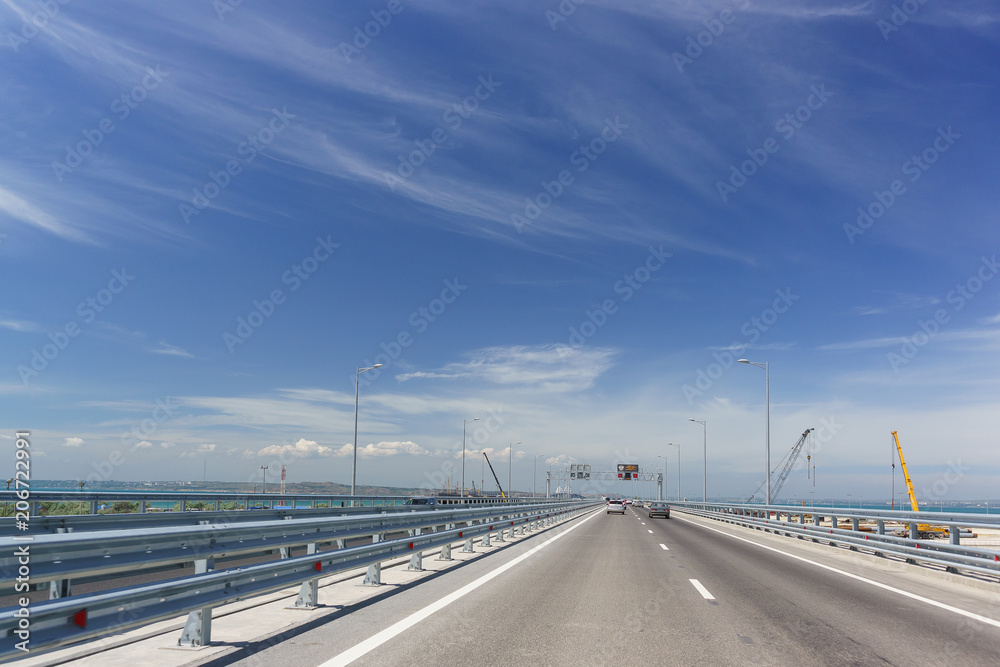 Cars go on the Crimean bridge on a Sunny day