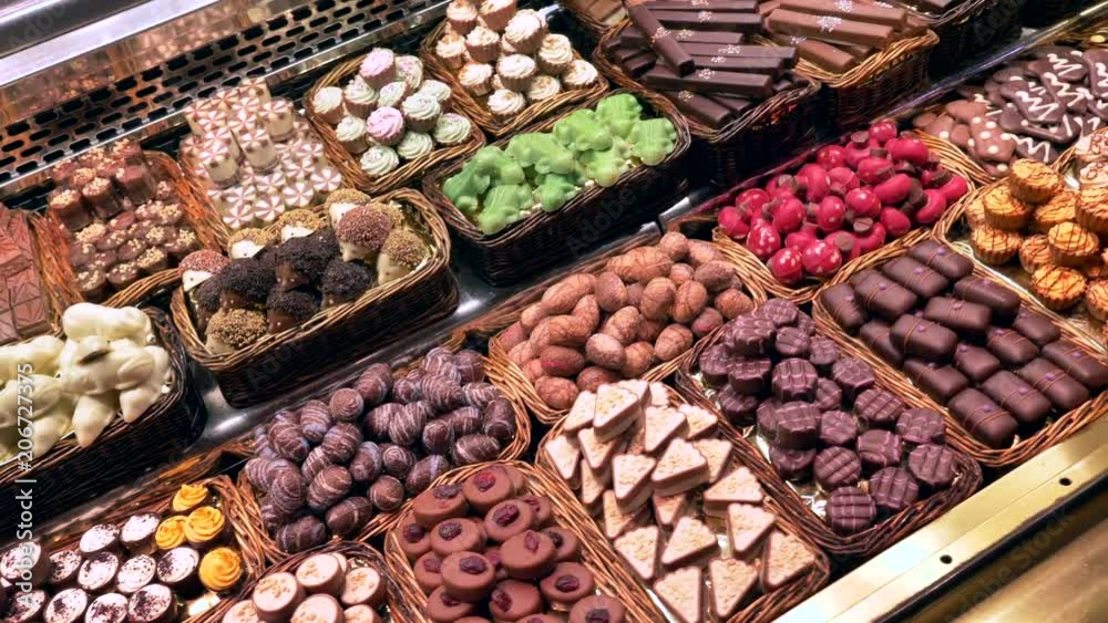 Dolly shot over Chocolate pralines display at La Boqueria market, Barcelona.
