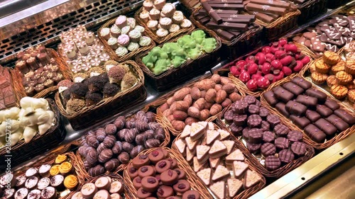 Dolly shot over Chocolate pralines display at La Boqueria market, Barcelona.
