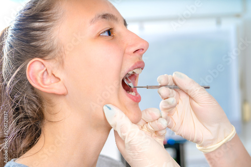 Dentist checking  for dental braces to the  patient.