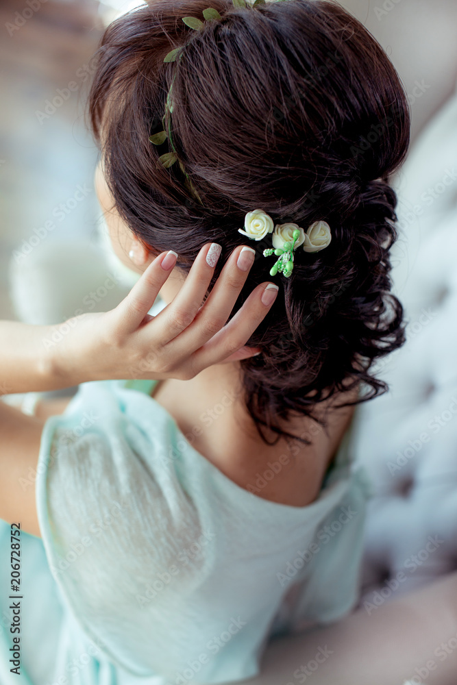 Naklejka premium beautiful bride in a white dress and veil with a hairdress and flowers hands in gloves, nipple shoulder décolletage