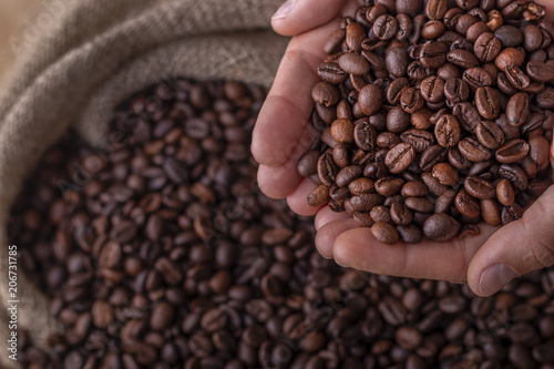 Картината върху платно Hands on a sack of coffee beans