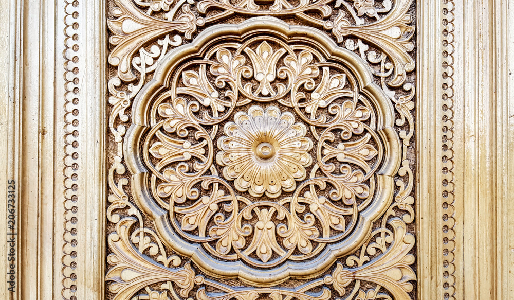 amazingly beautiful traditional Uzbek floral ornament carved on the wooden door of the mosque