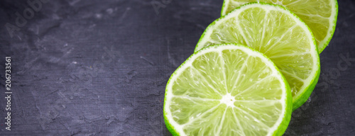 Slices of lime on a gray marble background
