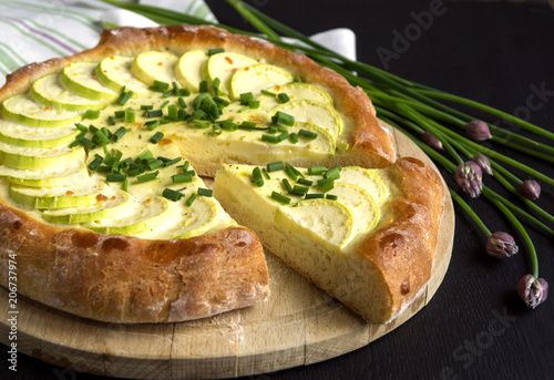 Homemade rustic pie with zucchini and green onions.