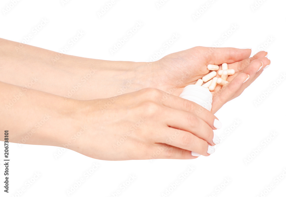White jar of pills in hand on white background isolation White jar of pills in hand on white background isolation
