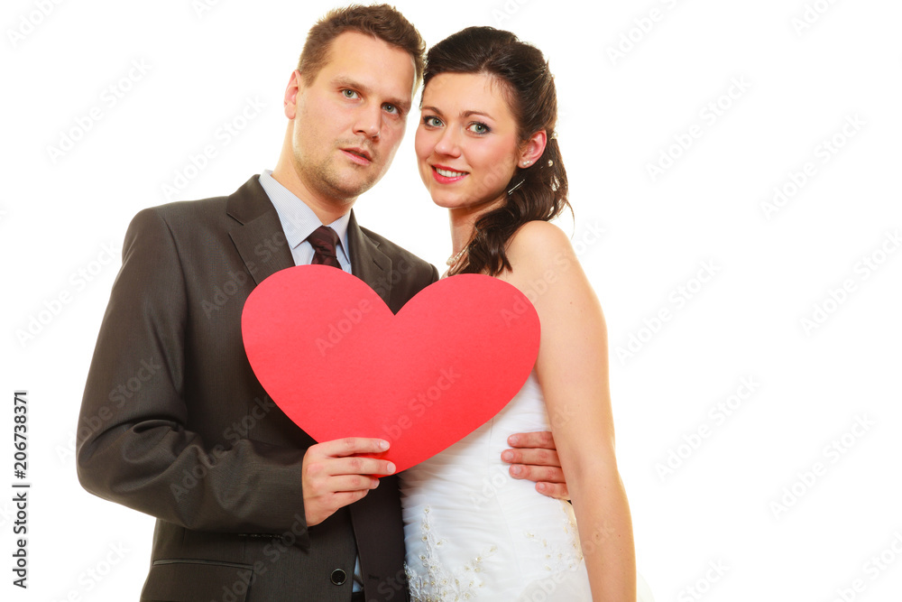 Groom and bride couple holding heart